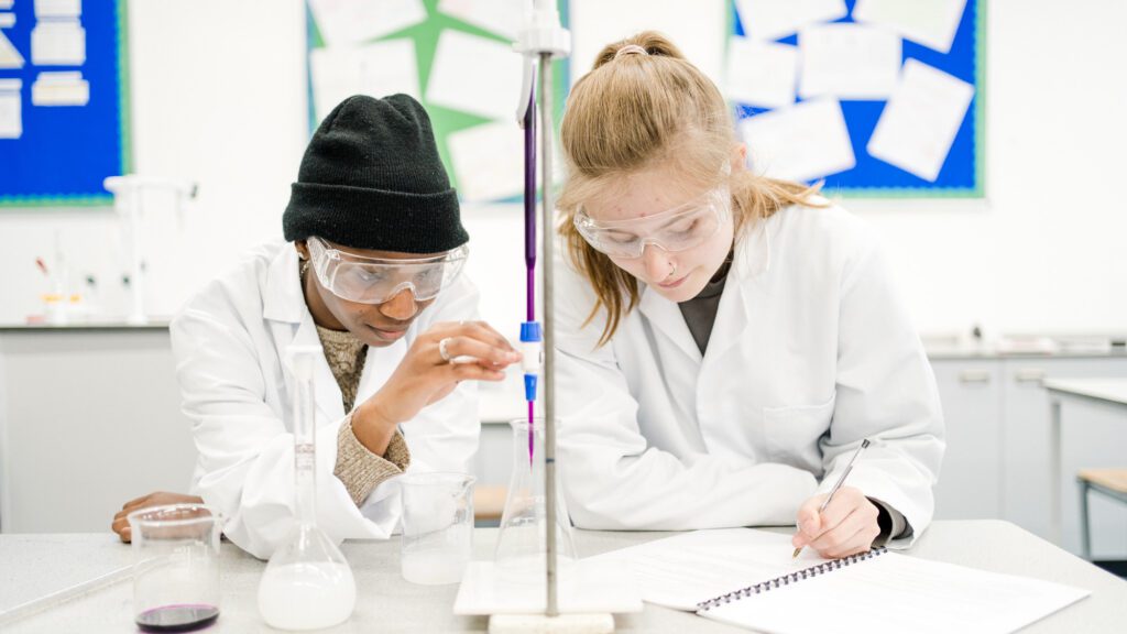Male and female students in the laboratory working on an experiment