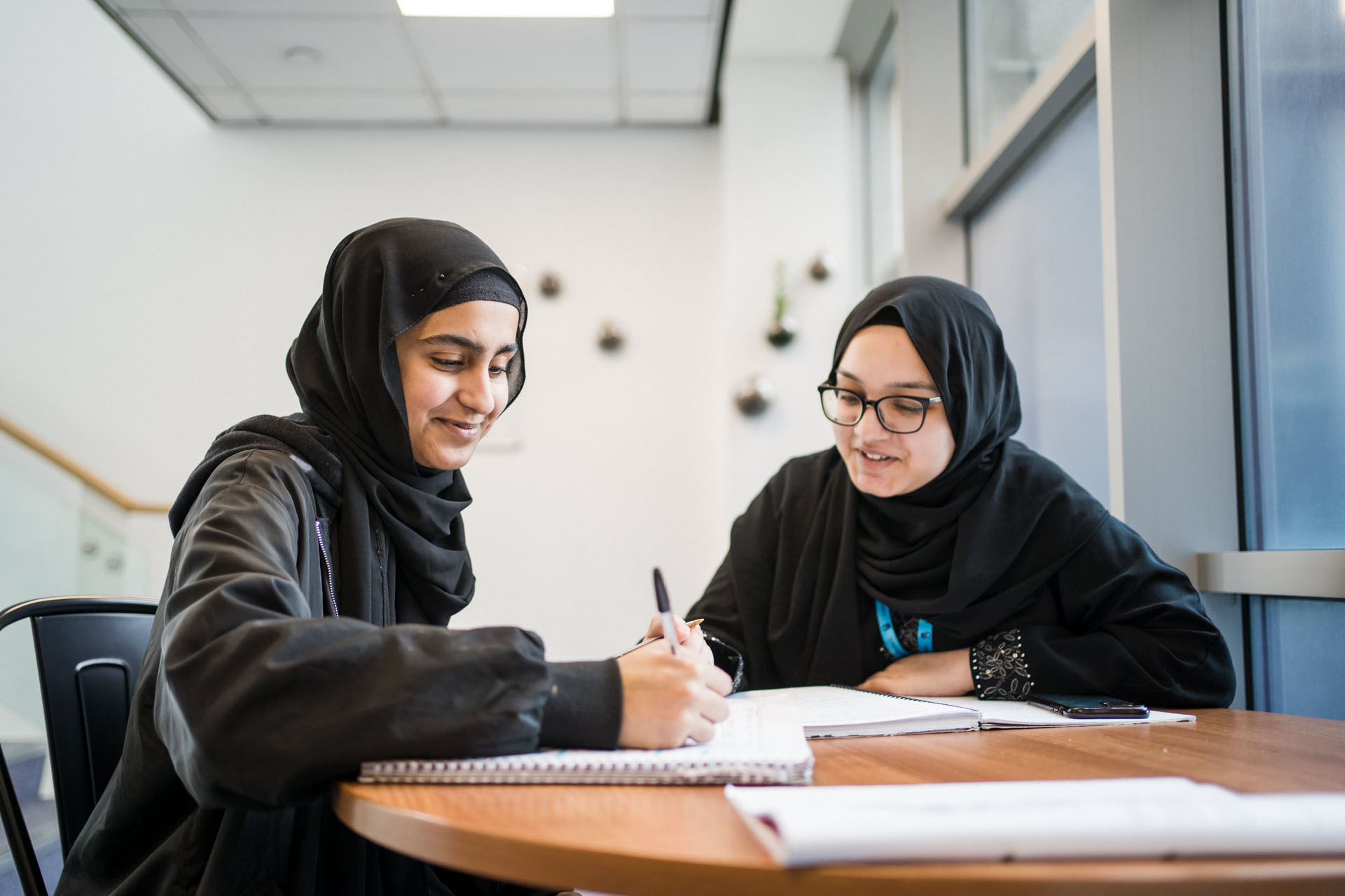 Two Leeds Sixth Form College students sat at their desks studying