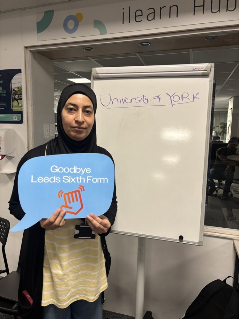 Jaweria Nasim holding a sign celebrating her results