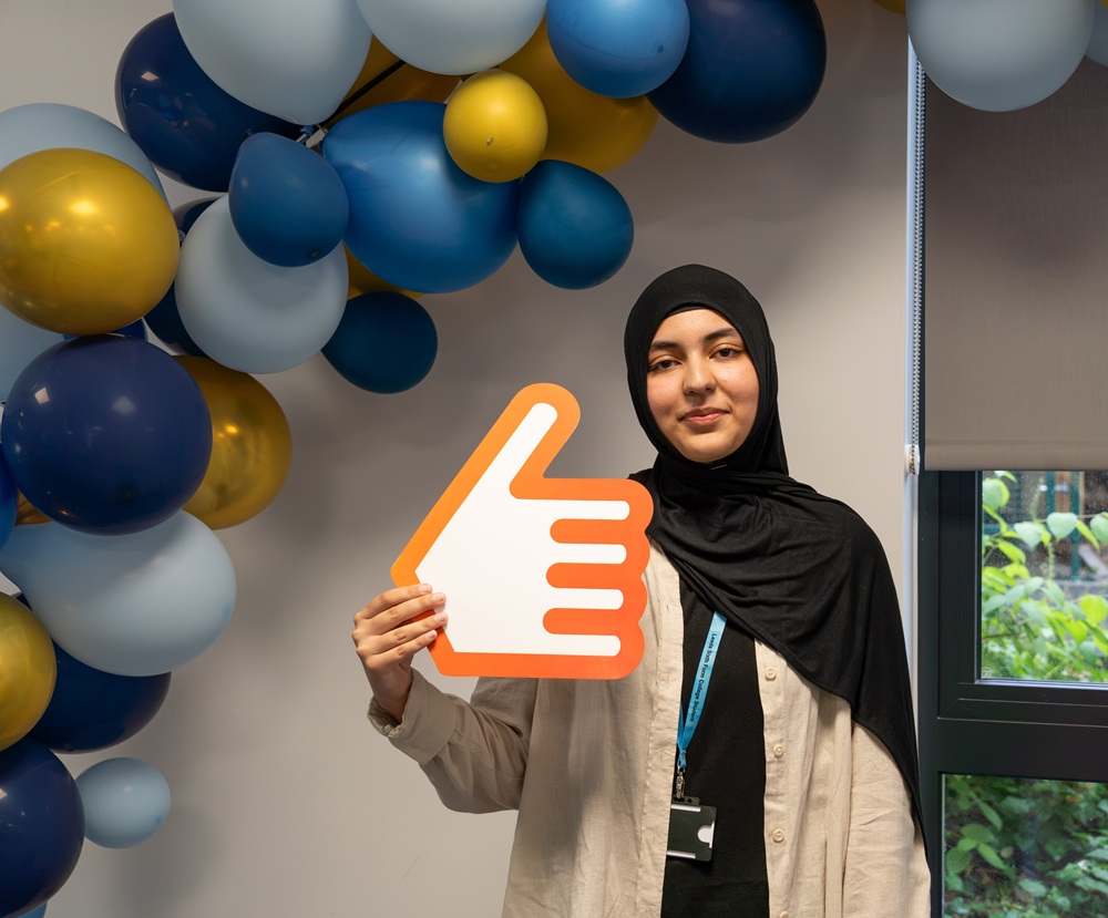 LSFC student Diya Eman celebrating, and holding a big thumbs up sign, on GCSE results day